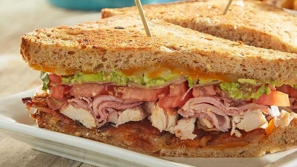 Sonoma Club Sandwich · Ham, turkey, baked bacon, guacamole, Cheddar Jack cheese, tomato and pickled red onions on your choice of white or nine-grain bread.