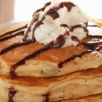 Kids' Chocolate Chip Gluten-Friendly Pancakes · Three kid-size cakes filled with chocolate chips and topped with fresh whipped cream and cho...