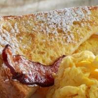 Kids' French Toast Sampler · One thick-sliced French toast topped with powdered sugar.  Served with scrambled egg and bak...