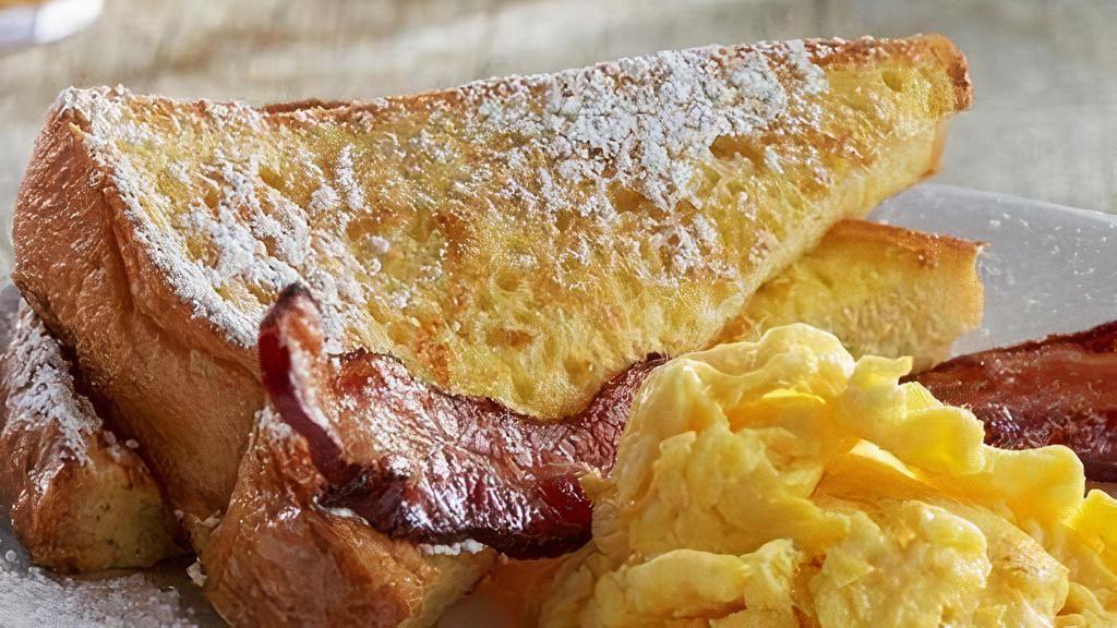 Kids' French Toast Sampler · One thick-sliced French toast topped with powdered sugar.  Served with scrambled egg and baked bacon.