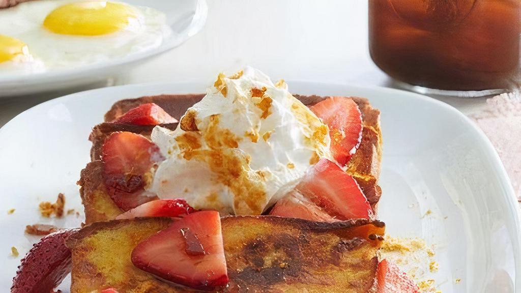 Strawberry Pound Cake French Toast · 20 pieces of French-toast style pound cake topped with fresh strawberries, fresh whipped cream and crème brulee sugar. Served with butter and syrup. (Serves 10)