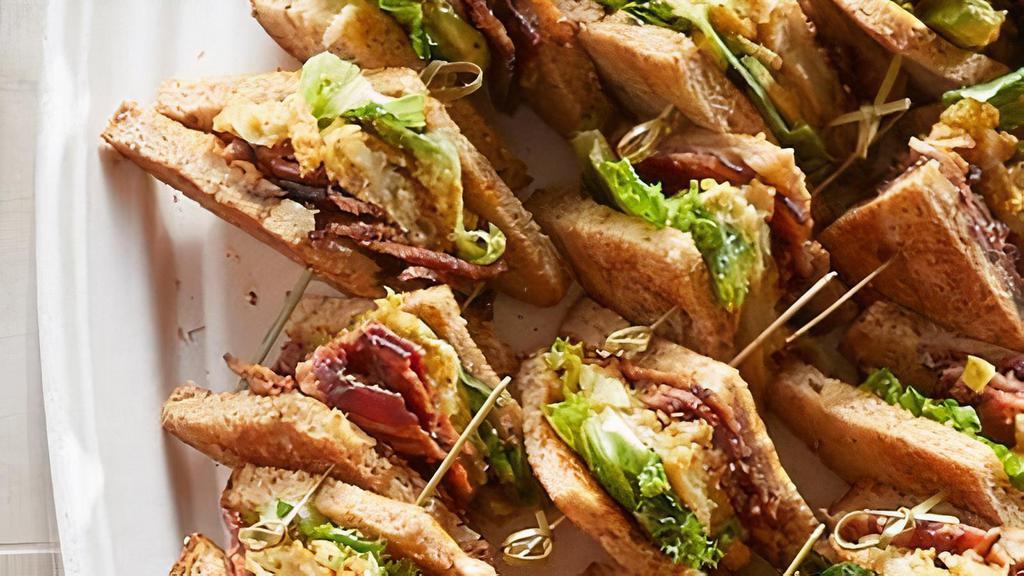 Bacon Lover'S Blt&A · Thick-cut baked bacon strips, lettuce, avocado, tomatoes and Cheddar Jack cheese with garlic aioli on nine-grain bread. (Serves 10)