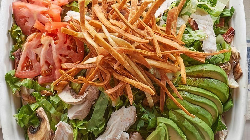 Southwest Chop Salad · Romaine, spinach, turkey, mushrooms, red onion, chopped bacon and black beans. Served with crispy tortilla strips, avocado, tomato slices and chipotle ranch. (Serves 10)