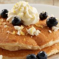 Lemon Blueberry Goat Cheese Pancakes - Vegetarian Option · Two house-recipe cakes filled with fresh blueberries and goat cheese, topped with lemon zest...