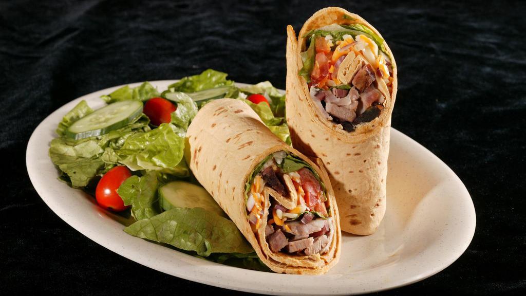 Southwest Wrap · Smoked turkey breast, bbq pork or mesquite-grilled chicken breast blended with corn, black beans, olives, red onion, tomatoes, cheddar jack cheese, and chipotle sauce, and perfectly packaged in a flour tortilla. Served with your choice of one creamy coleslaw, french fries, mashed potatoes and gravy, baked or sweet potato, and bbq beans or country vegetables.