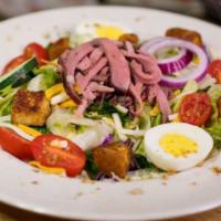 Woody’S Famous Bar-B-Q Salad · Herbivore meets carnivore in this cool, crisp salad of lettuce, tomatoes, cucumber, egg and ...