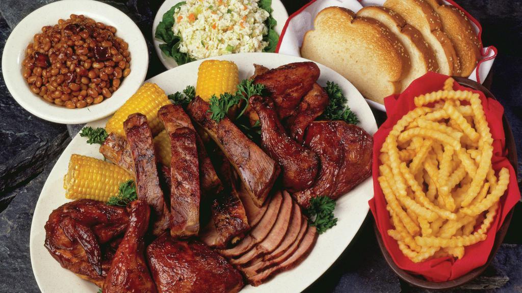 Woody'S Family Feast For 4 · Family-sized portions of bbq pork, bbq chicken and spare ribs served with bbq beans, creamy coleslaw, french fries, fried corn on the cob, and garlic toast.
