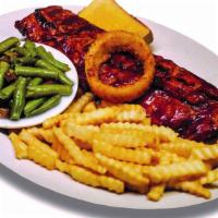 Woody’S Signature Baby Back Ribs · A tradition for nearly four decades. All dinners include garlic toast and your choice of two...