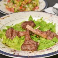 Lamb Chops · Lamb marinated in herbs and spices served with three side choices.