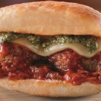 Smashed Meatball Slider · Two meatballs topped with marinara, sliced mozzarella, baked and finished with a basil pesto...
