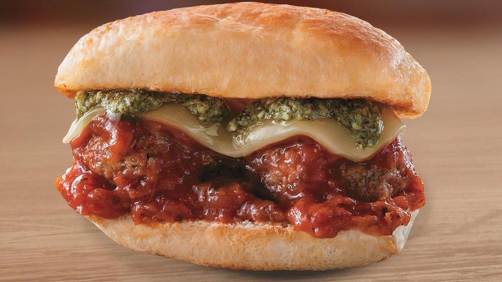 Smashed Meatball Slider · Two meatballs topped with marinara, sliced mozzarella, baked and finished with a basil pesto drizzle.