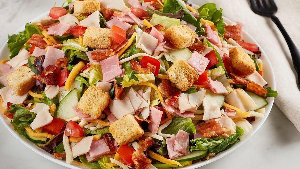Chef Salad · Diced Turkey and ham, bacon, cheddar-jack, tomato, croutons and cucumber on mixed greens.