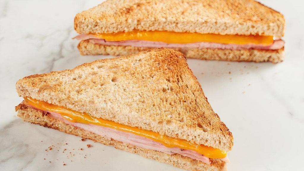 Kids Ham Toastie  · American cheese with ham on toasted wheat bread. Comes with your choice of a side and a Mini Chocolate Chip Cookie.