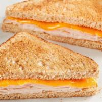 Kids Turkey Toastie · American cheese with turkey on toasted wheat bread. Comes with your choice of a side and a M...