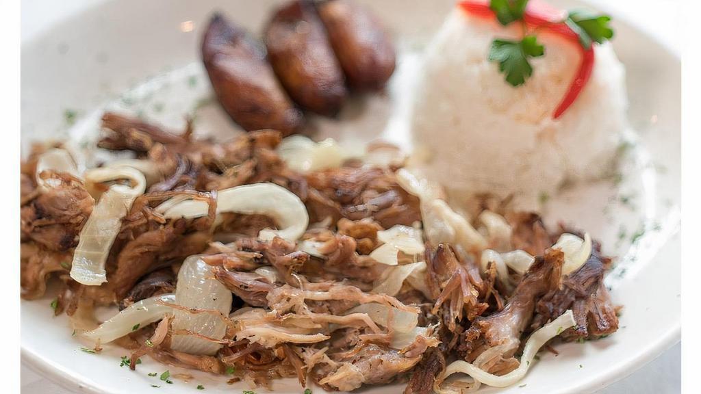 Roast Pork · Traditionally our national dish marinated in tasty tropical spices and mojo juice. Oven roasted then grilled with sauteed onions. Served with white rice, black beans and sweet plantains