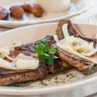 Pork Chops · Two sliced chops grilled served with chopped onions and parsley, white rice, black beans and...