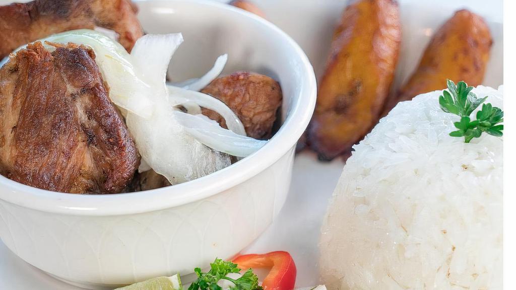 Pork Chunks · Deep fried pork cubes until golden brown, sprinkled with mojo juice and topped with sauteed onions. Served with white rice, black beans and sweet plantains.