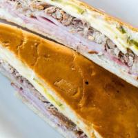 Cuban Sandwich · Serrano ham, swiss cheese, pickles, roast pork and mayonnaise on a cuban bread crispy toasted.
