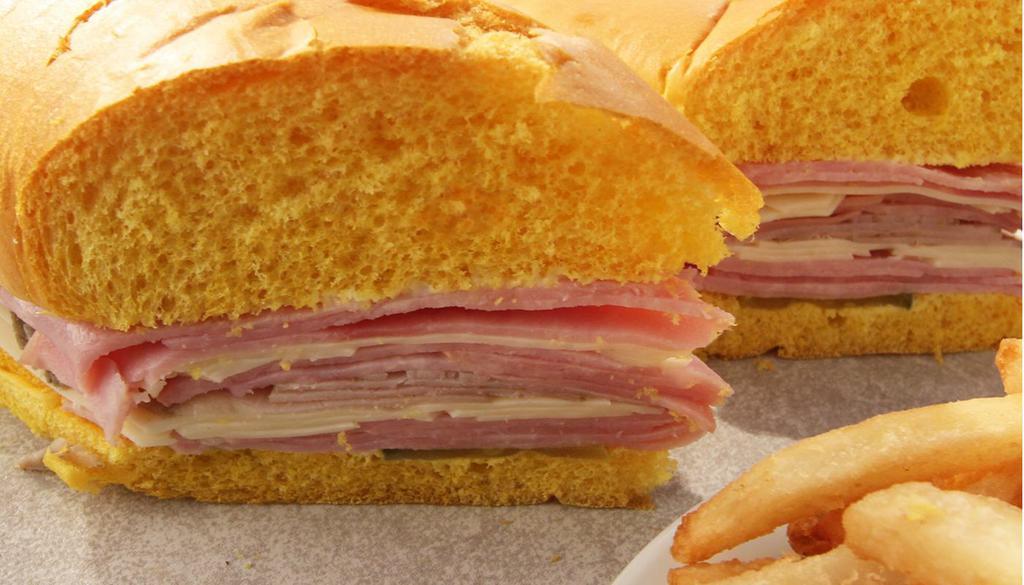 Midnight Sandwich · Midnight Sandwich: Serrano ham, Swiss cheese, pickles, roast pork, mayonnaise on a sweet egg bread roll.