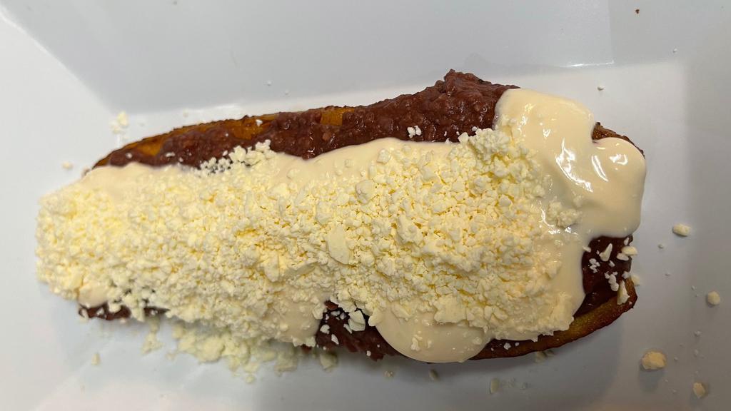 Maduro Relleno ( Frijol Molido, Crema & Queso) · Stuffed Sweet Plantain with mashed beans, cream & crumbled cheese.
