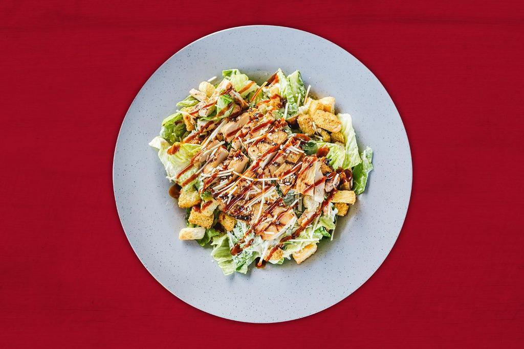 Smokin Caesar Salad · Chopped Romaine topped with croutons and shredded Parmesan, served with Caesar dressing and a drizzle of Smokin' BBQ Sauce. Add your favorite BBQ meat for a little bit more.