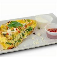 Spinach Feta Womelette · Eggs, spinach, feta, basil, onions, peppers, tomatoes and black pepper. Served with choice o...