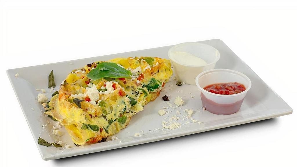 Spinach Feta Womelette · Eggs, spinach, feta, basil, onions, peppers, tomatoes and black pepper. Served with choice of salsa or sour cream.