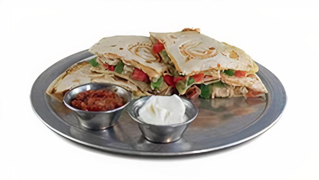 Chicken Quesadilla · Diced chicken breast, pepperjack cheese, peppers, onions, tomatoes and jalapeno waffled in a flour tortilla.  Served with salsa and sour cream.