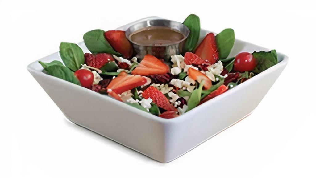 Spinach Strawberry Salad · Bed of spinach topped with feta cheese, strawberries, dried cranberries, and slivered almonds, grape tomatoes, served with a side of balsamic vinaigrette.