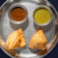 Viscious Veggie Samosa · Idaho potatoes mixed in a curry marinated and fried in a crispy wheat layer. Served with tam...