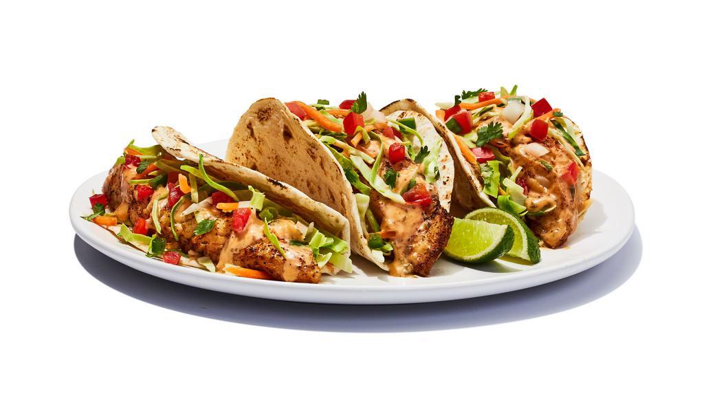 Fish Tacos Grilled · Grilled cod served on soft tortillas with diced tomato, cabbage and house spicy sauce. . 700 cal
