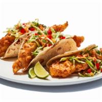 Fish Tacos Fried · Tempura battered cod served on soft tortillas with diced tomatoes, cabbage and house spicy s...