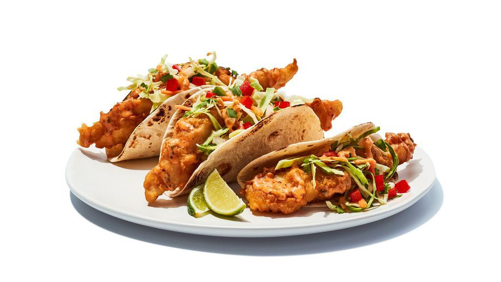 Fish Tacos Fried · Tempura battered cod served on soft tortillas with diced tomatoes, cabbage and house spicy sauce.   850 cal