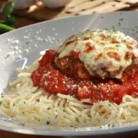 Chicken Parmigiana · Breaded chicken baked in our marinara sauce, topped with melted mozzarella. Served on a bed ...