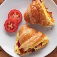 Breakfast Croissant Sandwich · Scrambled eggs with sausage, ham or bacon, topped with fresh cheddar on a flaky butter crois...