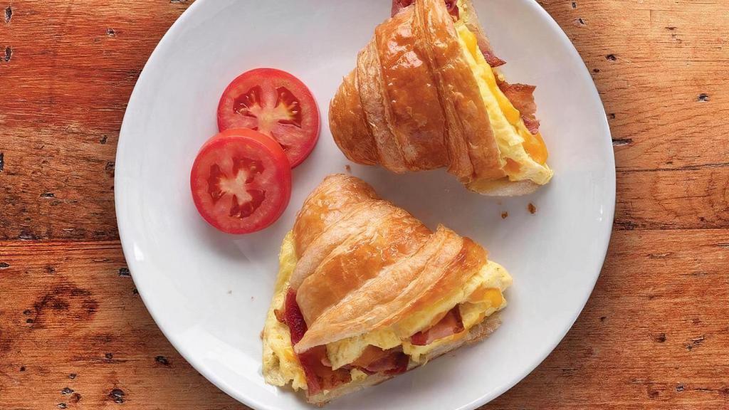 Breakfast Croissant Sandwich · Scrambled eggs with sausage, ham or bacon, topped with fresh cheddar on a flaky butter croissant.