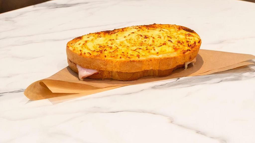 Croque Monsieur · Savory sliced smoked ham and Swiss topped with garlic cream sauce baked on new country bread. Served with your choice of one signature side.