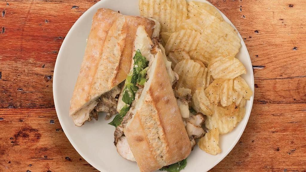 Chicken Caesar Sandwich · Shaved, balsamic-marinated chicken and our famous Caesar Salad with Swiss and mayonnaise baked on a baguettine served with your choice of one signature side.