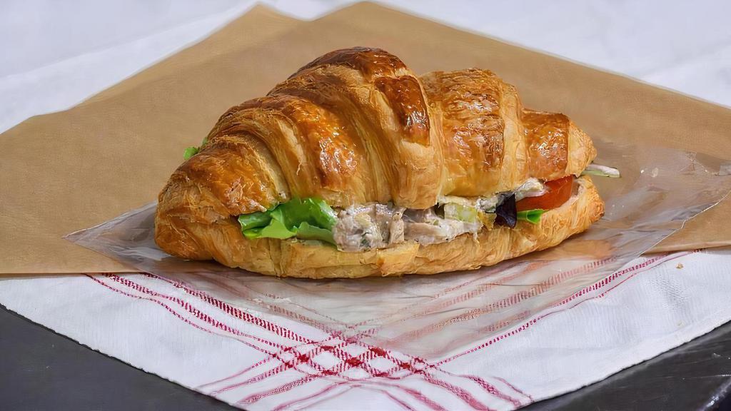 Chicken Salad Croissant · Chicken Salad served cold with crisp lettuce and tomatoes on a freshly-baked, flaky butter croissant served with your choice of one signature side.