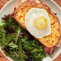 Croque Madame · Smoked ham & Swiss with garlic cream sauce baked on country bread. Topped with a fried egg.