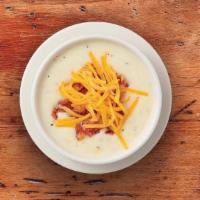 Country Potato · Our creamy potato soupe accented with leeks and onions. Garnished with cheddar cheese and ch...