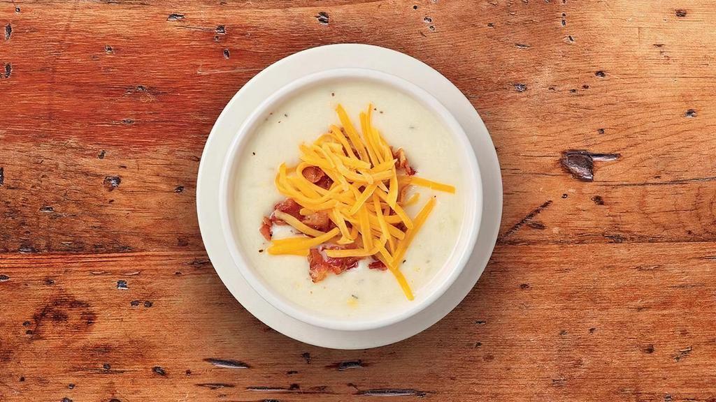 Country Potato · Our creamy potato soupe accented with leeks and onions. Garnished with cheddar cheese and chopped bacon.