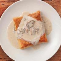 Chicken Friand · Tender chicken, mushroom, onion and Swiss filling in a flaky puff pastry shell topped with o...