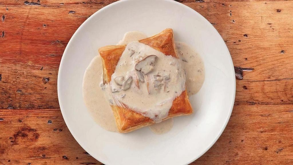 Chicken Friand · Tender chicken, mushroom, onion and Swiss filling in a flaky puff pastry shell topped with our creamy wild mushroom sauce.