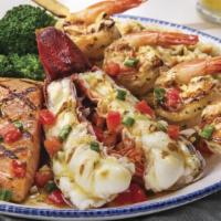 Grilled Lobster, Shrimp And Salmon** · Tender Maine lobster tail, jumbo shrimp skewer and Atlantic salmon, finished with a brown bu...