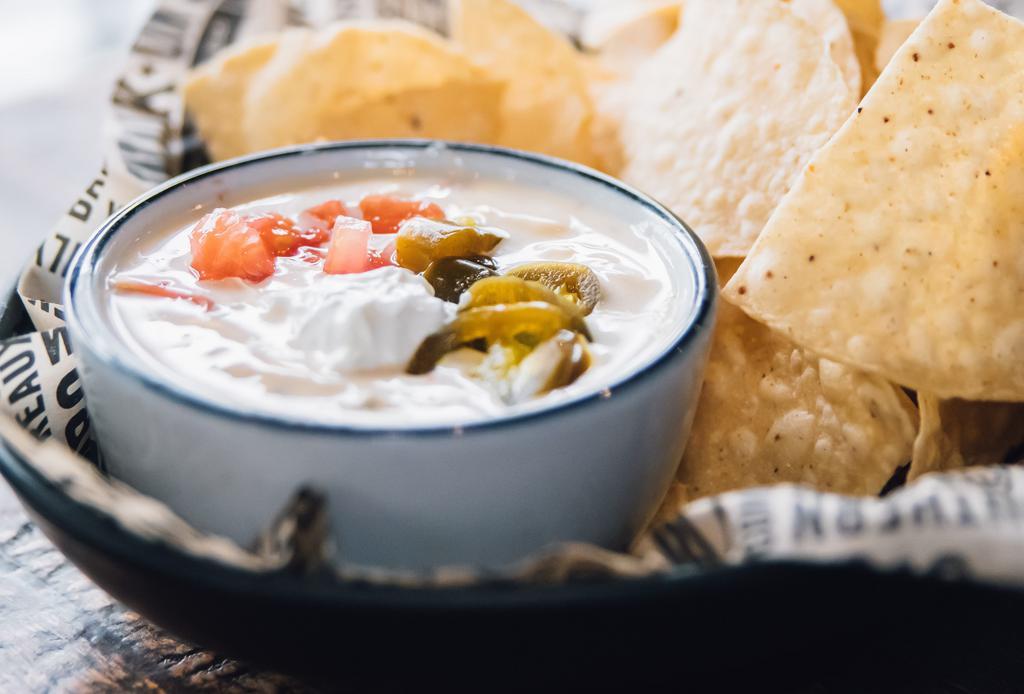 Cajun Queseaux® · Melted blend of cheeses, with sour cream, jalapenos, diced tomatoes.  Served with warm tortilla chips