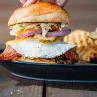 The Hangover · Half pound burger, sunny side up egg, American, bacon, waffle fries, dressed, brioche bun.