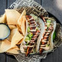 Blackened Redfish Tacos · Blackened redfish, chipotle slaw, avocado, and lime crema, with Chips and queso.