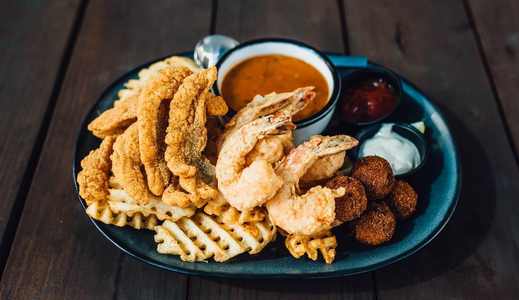 Louisiana Combo · Fried shrimp, fried catfish, hush puppies, waffle fries with cocktail and tartar served with crawfish étouffée.