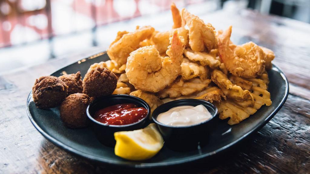 Fried Jumbo Shrimp · Gulf caught, hand battered, waffle fries, hush puppies, with cocktail and tartar.